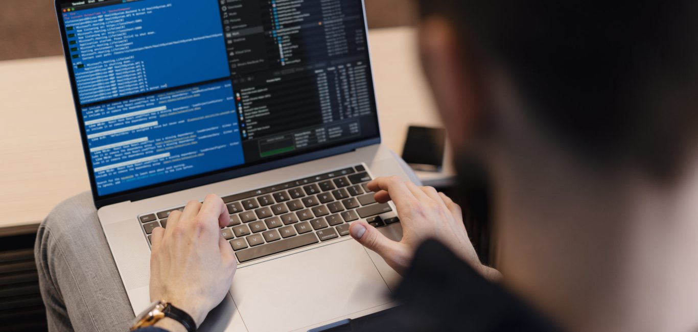 Man working on computer. Young it worker using laptop in the office, Internet marketing, technology, finance, business concept