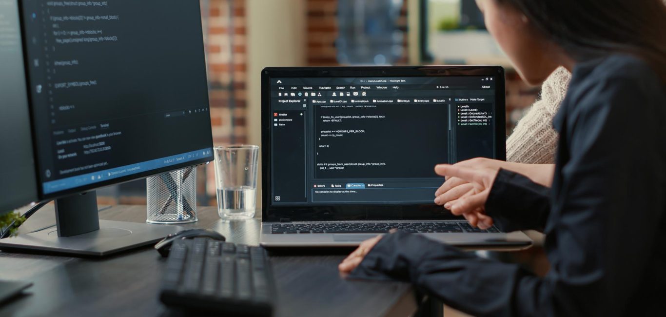 team-programmers-talking-about-algorithm-running-laptop-screen-pointing-source-code-while-sitting-desk-software-developers-collaborating-data-coding-group-project